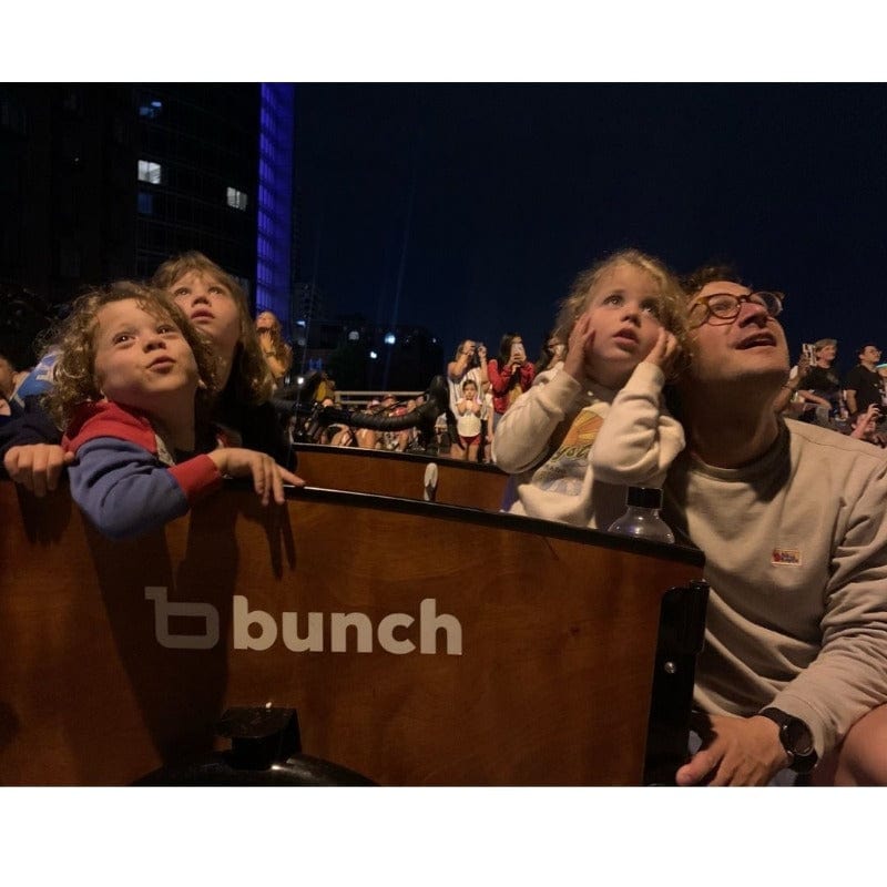 Family watching fireworks in a Bunch Bike #color_Classic Sedona Woodgrain