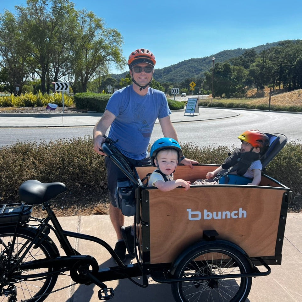 Two kids in Bunch Bike with adaptive seating for special needs #color_Honey Woodgrain