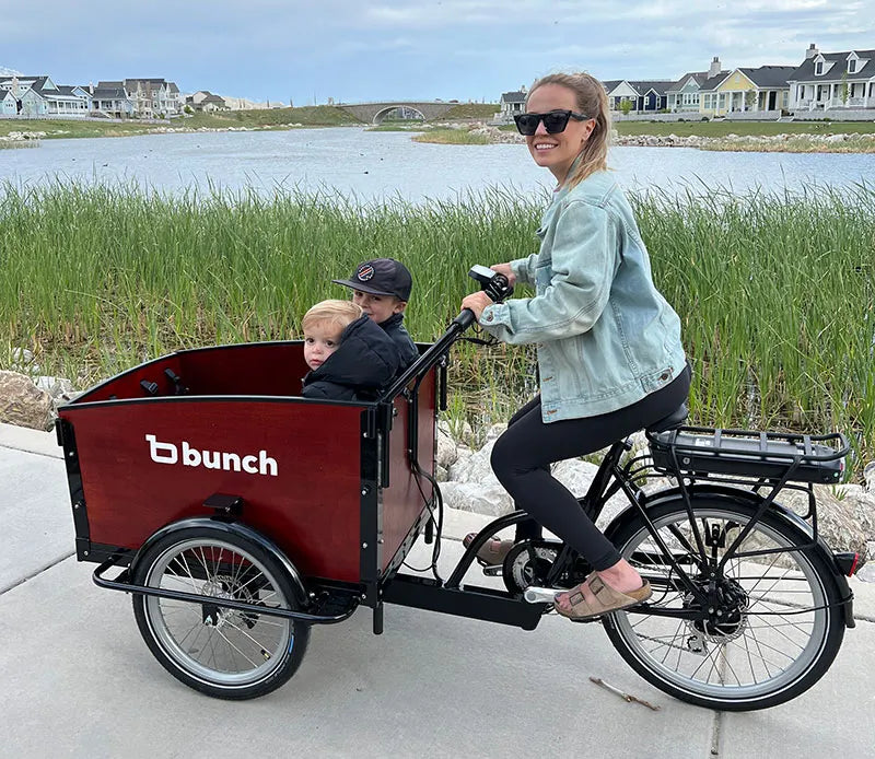 Mom and 2 kids on bunch bikes cargo bike