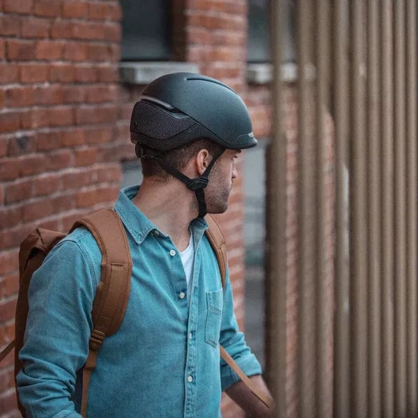 side view of male cyclist wearing faro smart helmet