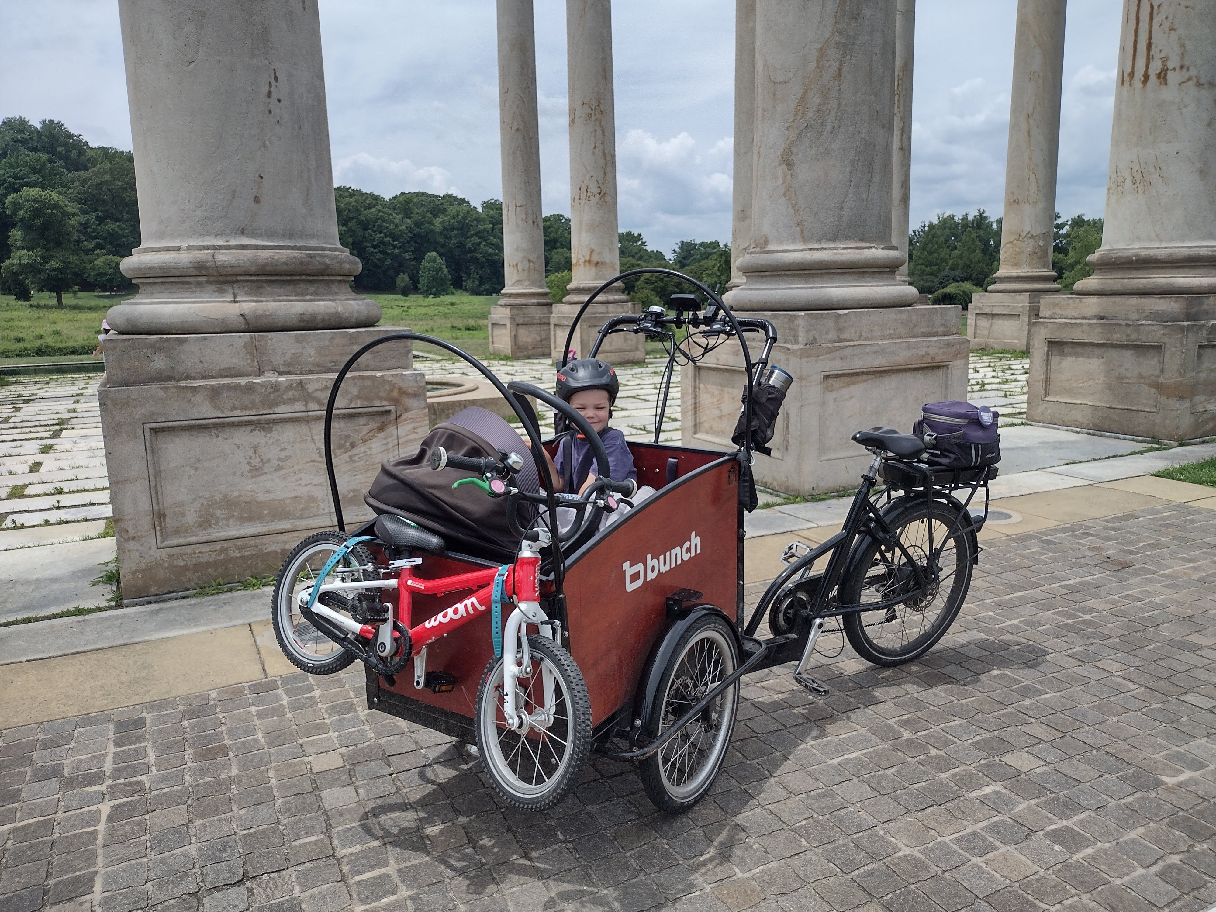 Baby in Bunch Bike with older child on two wheeled bike