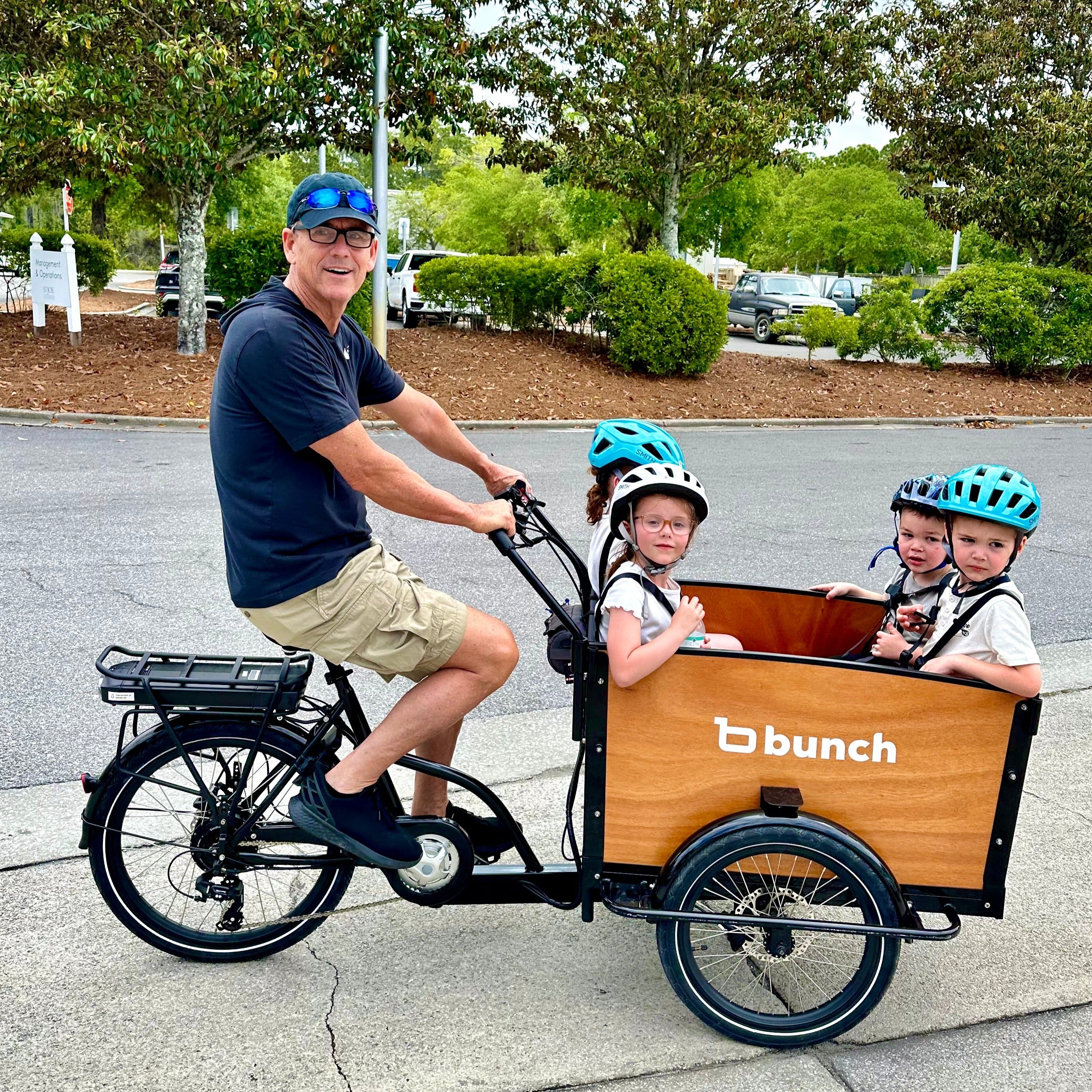 Four kids in Original 4 Bunch Bike - #color_Honey Woodgrain