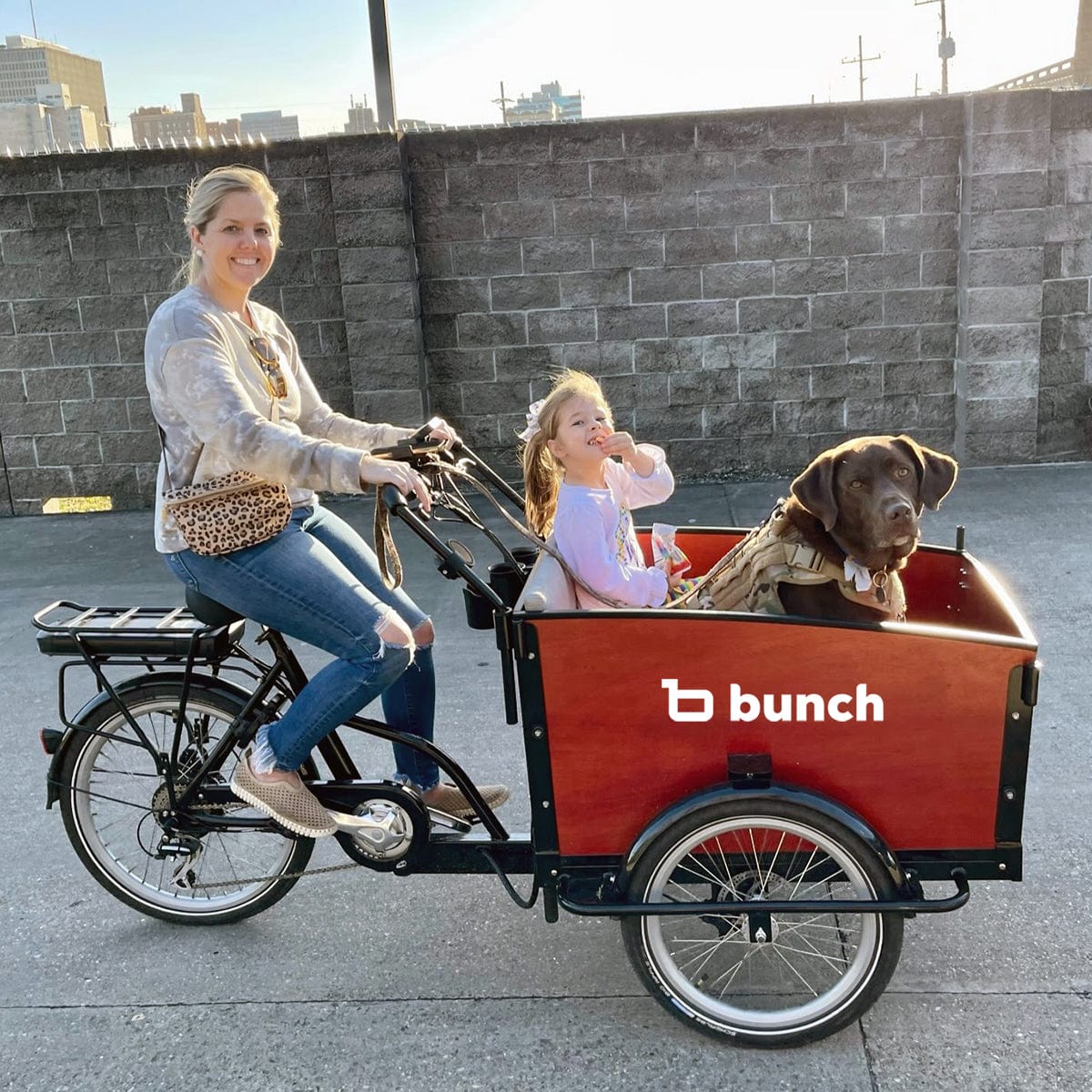 Woman with dog and girl in bunch bike k9 electric cargo bike for dogs #color_Sedona Woodgrain