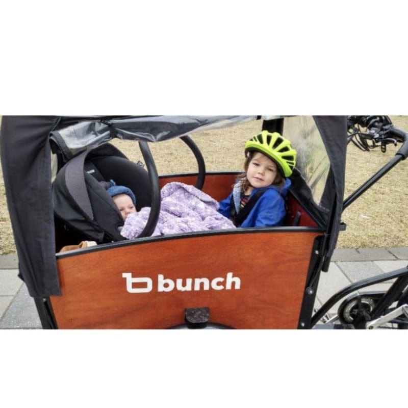 Baby in BabyMee car seat adapter with toddler in Bunch Bike electric cargo trike